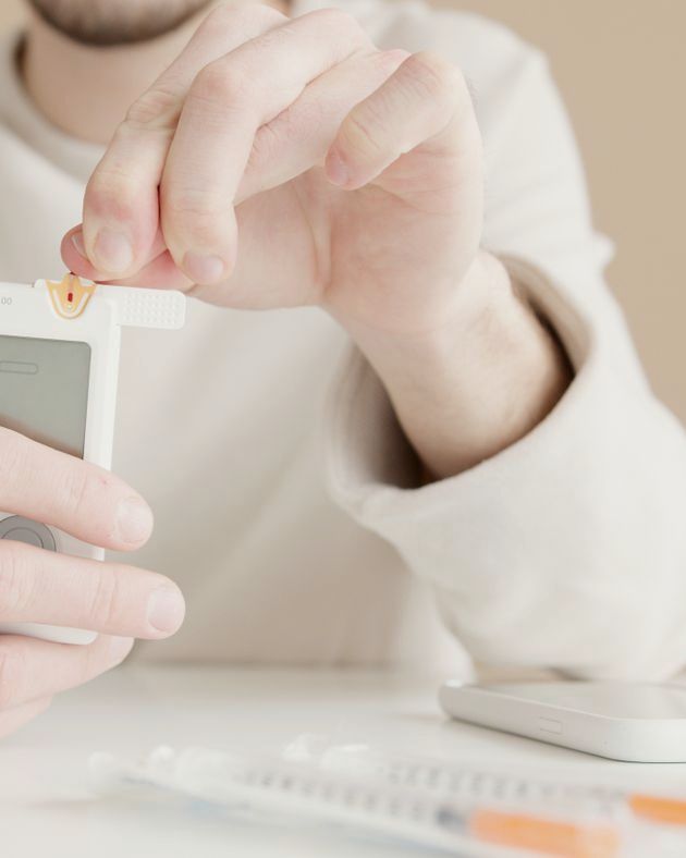 A man checking his blood sugar at home