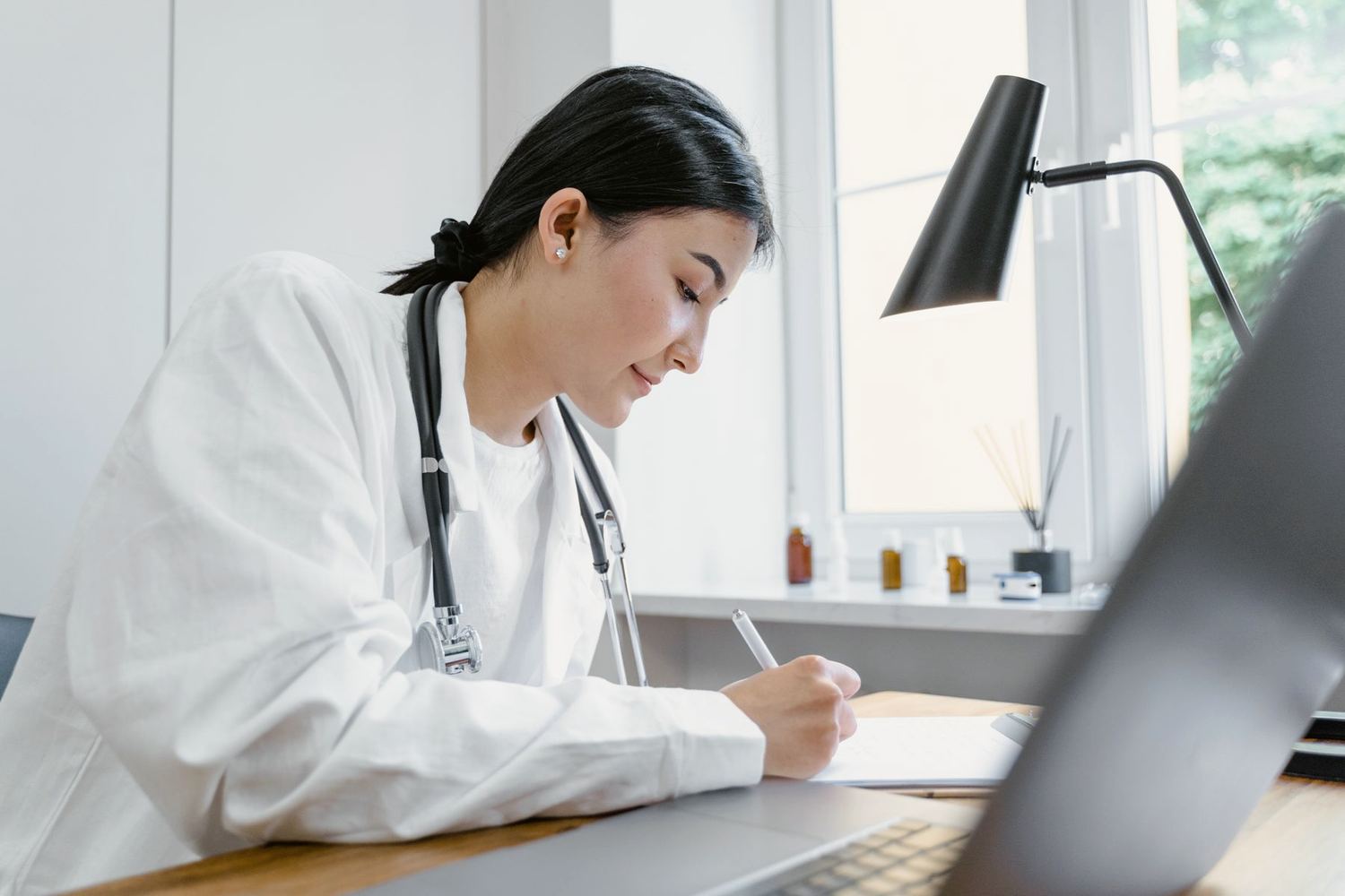 The doctor taking notes at her desk